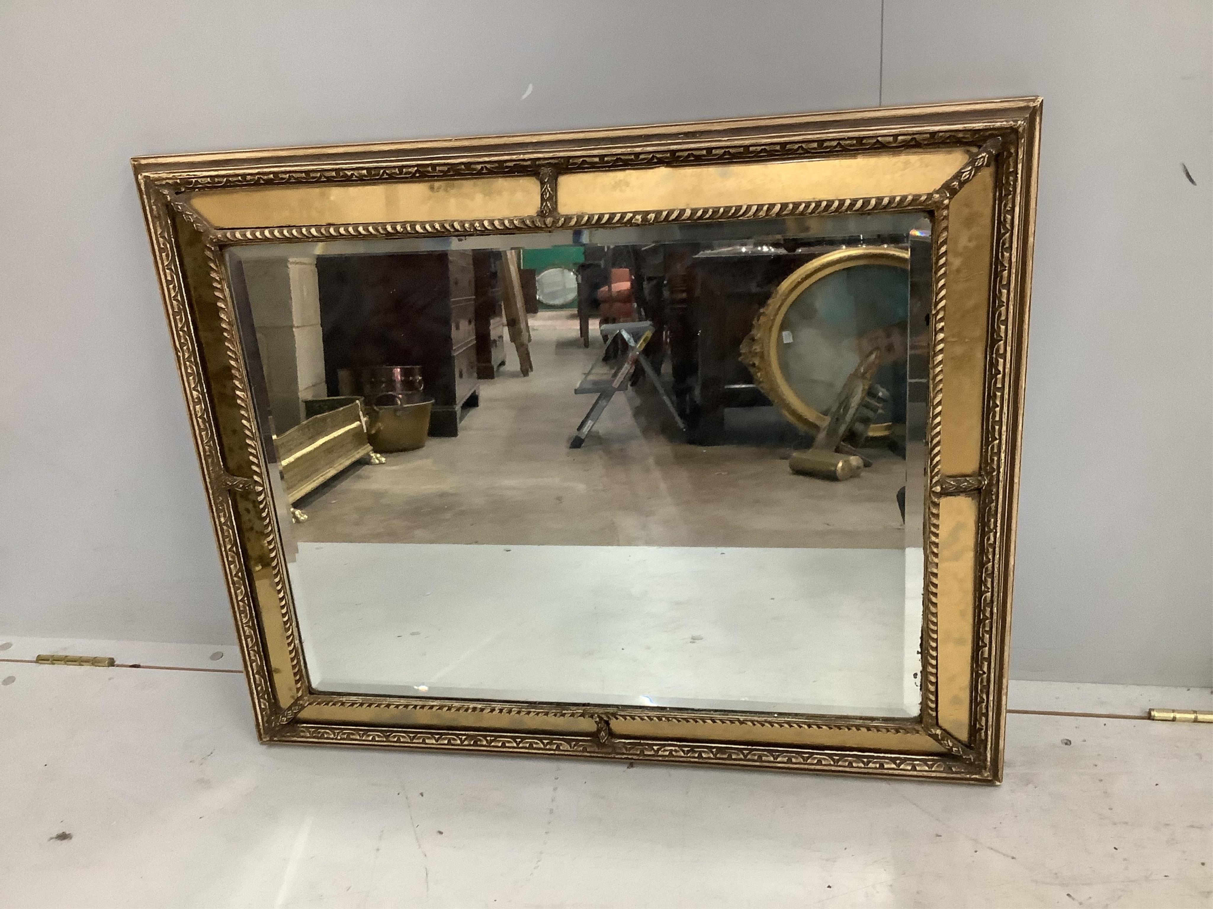 A pair of Regency style rectangular giltwood and composition marginal plate cushion framed mirrors, width 66cm, height 83cm. Condition - fair to good